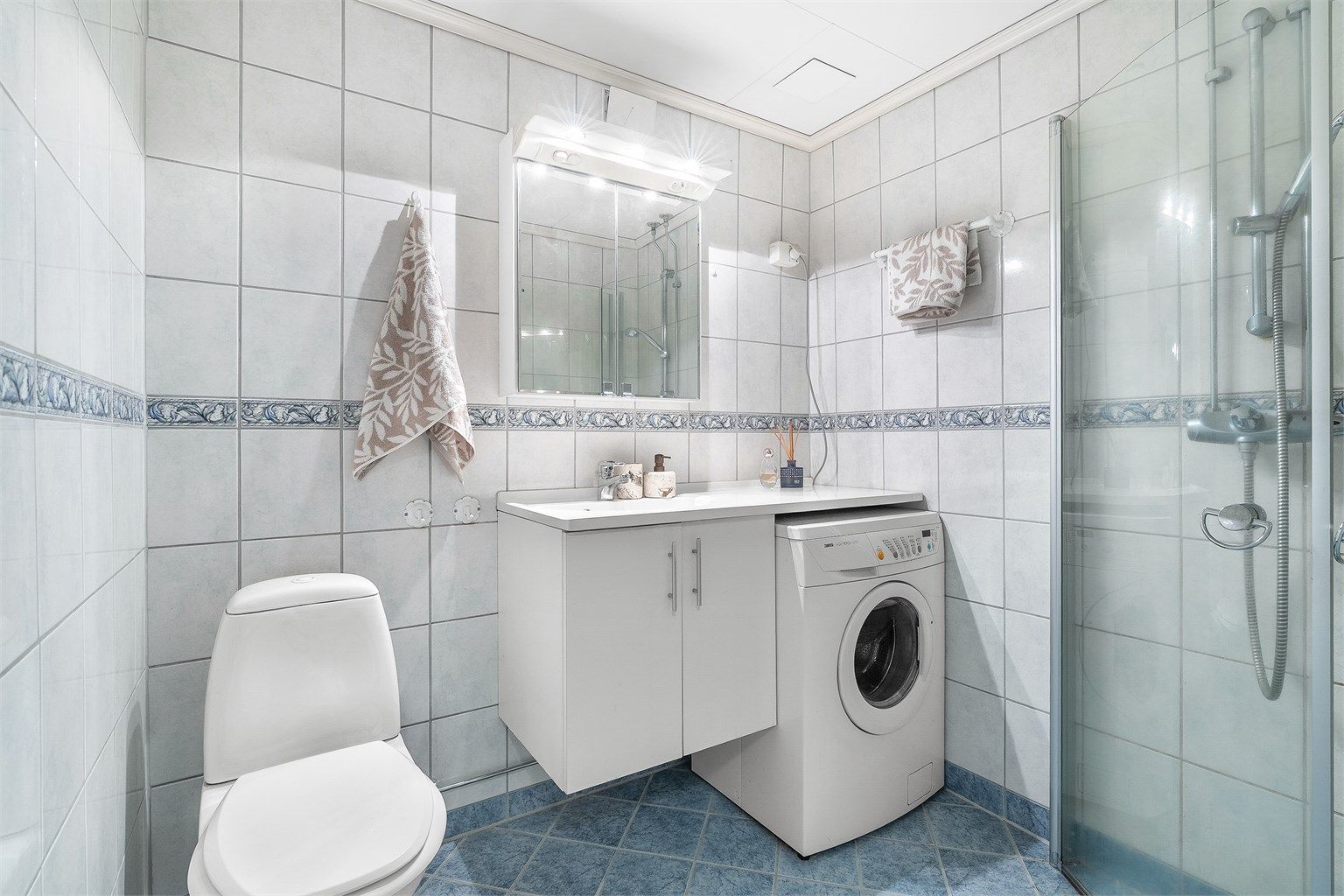 Flislagt bad med varmekabler i gulvet for økt komfort. Vaskemaskinen medfølger handelen.