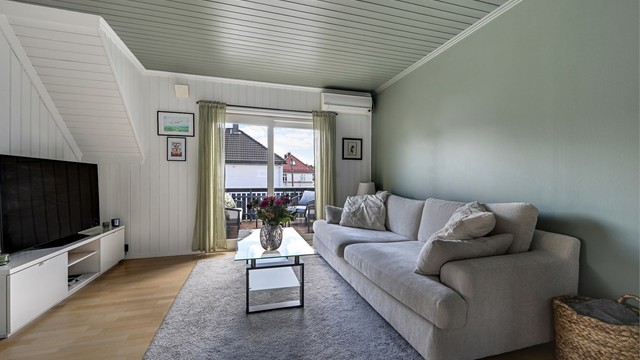 En luft-til-luft varmepumpe er plassert i stuen og gir effektiv oppvarming.