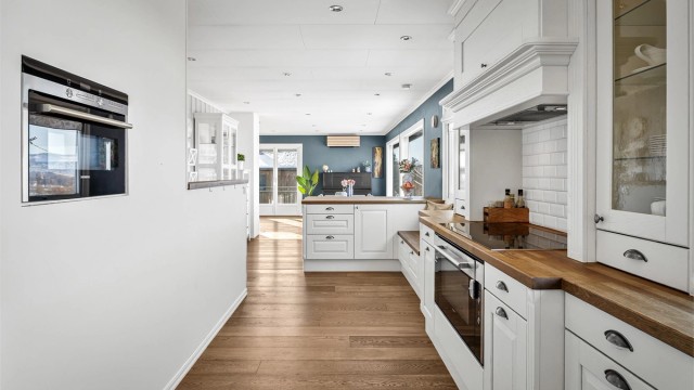 Kjøkkenet er utstyrt med delvis integrerte hvitvarer.