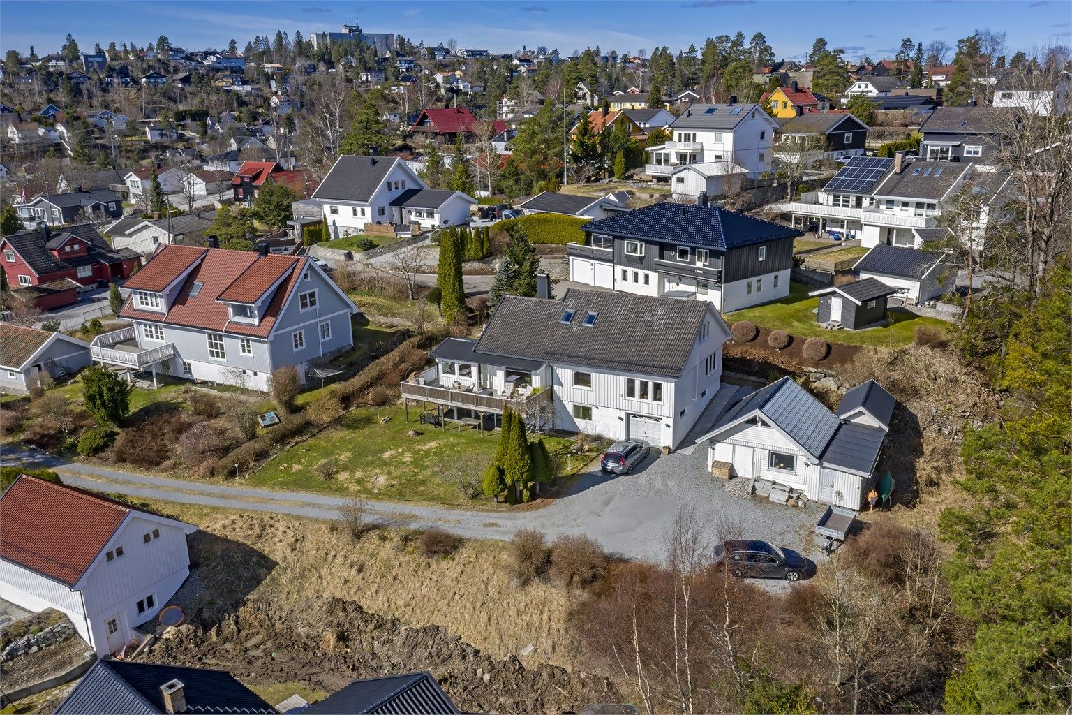 Innholdsrik eiendom med stor tomt (1.439 kvm) - tilliggende garasje i boligen samt frittstående garasje/verksted - romslig gårdsplass