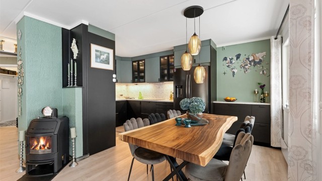 I åpen løsning mot stuen finner du et lekkert kjøkken fra 2022 med glatte fronter på skap og skuffer, og benkeplate av stein med nedfelt kjøkkenvask