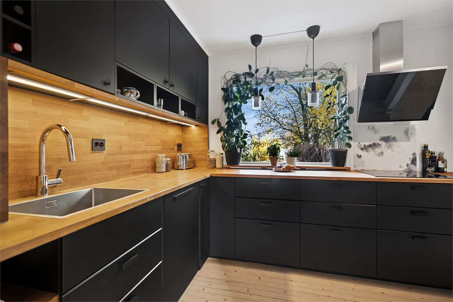 Rikelig med skapplass, god arbeidsbelysning og benkeplate i heltre eik gir et komfortabelt og ryddig kjøkkenmiljø.