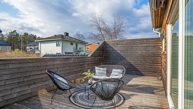 Uteplassen er skjermet med tett rekkverk i tre.