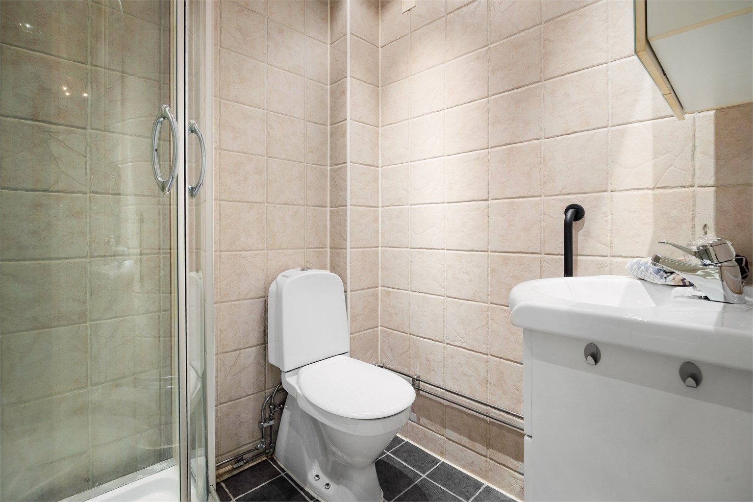 Badet er også innredet med servantinnredning med speilskap over. 