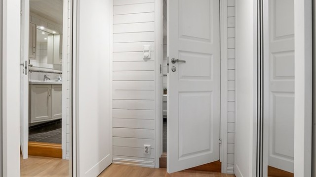 Walk-in garderobe med praktisk skyvedørsløsning og rikelig med oppbevaringsplass.