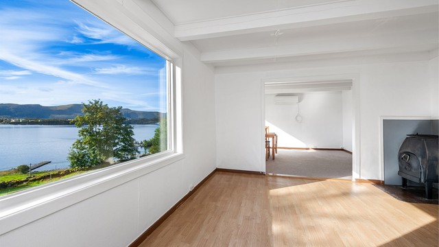 Stuen har store vindusflater med utsikt mot fjorden og de omkringliggende Sunnmørsalpene.
