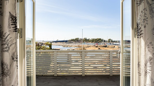 Terrassedøren bokstavelig talt åpner stuen mot utearealet og slipper havbrisen inn til stuen.