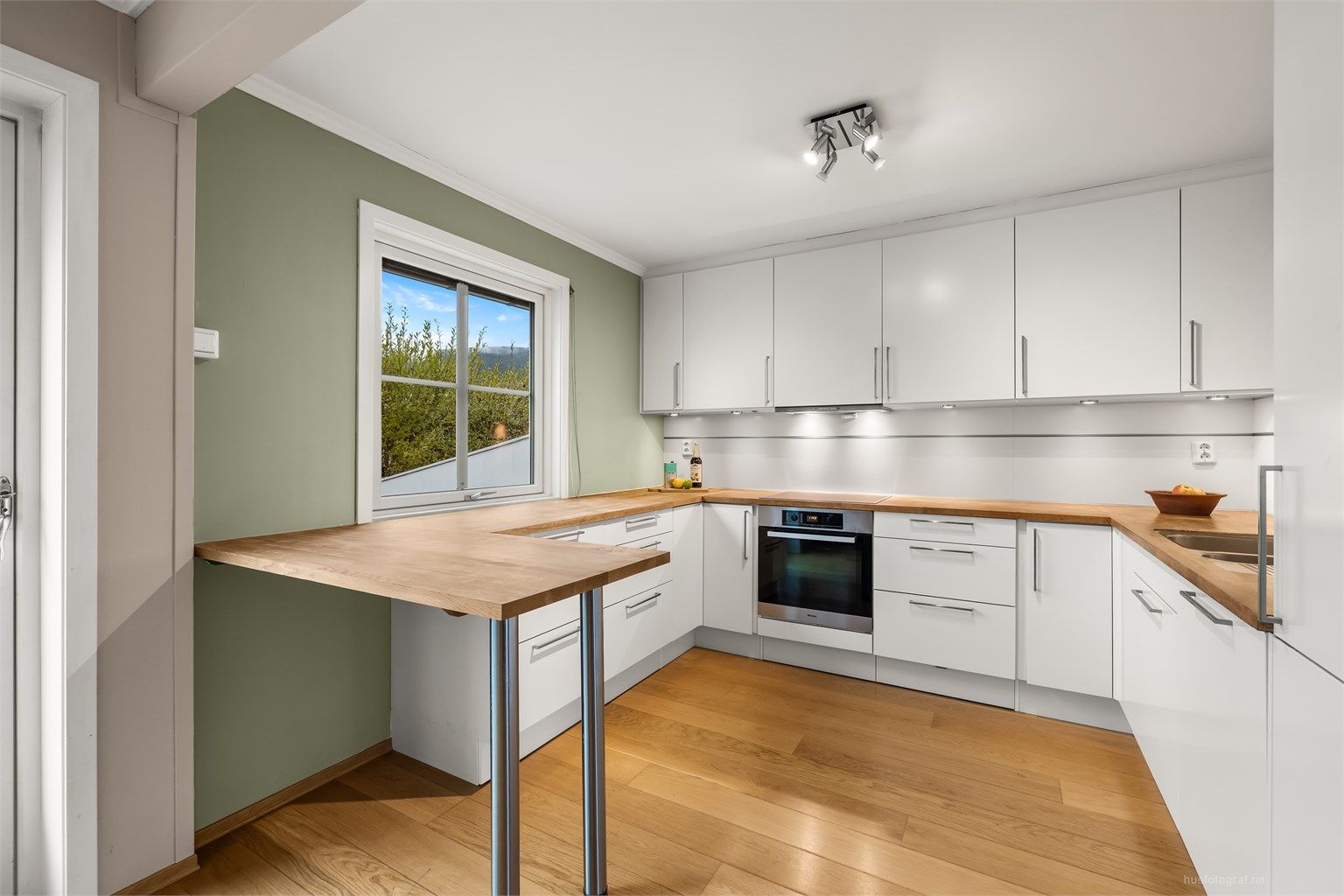 Kjøkkeninnredningen er fra HTH og har rikelig med skap- og benkeplass.