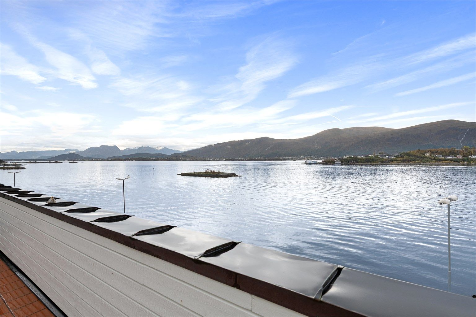 Utsikt mot sjøen og omkringliggende landskap fra balkongen.
