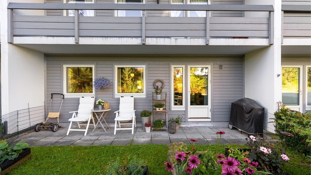 Den østvendte markterrassen har hellelagt dekke og plass til sittegruppe og grill.