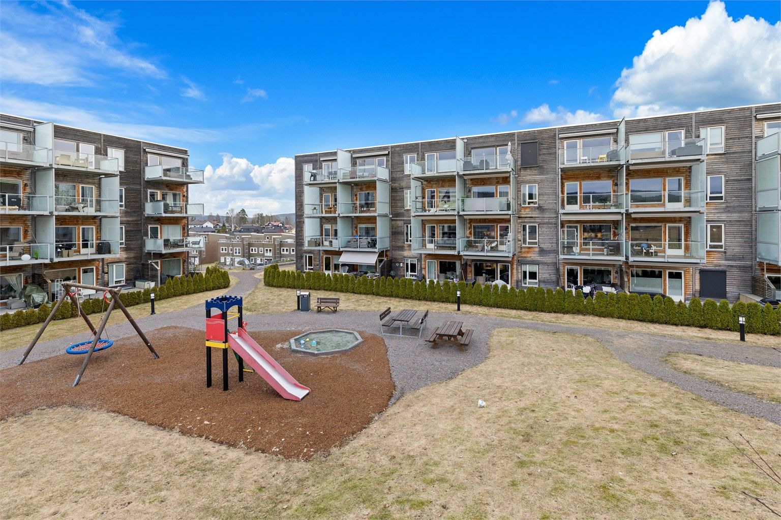 Sameiet har hyggelige fellesarealer som er pent opparbeidet med plener, singlede adkomststuer og hyggelig lekeplass for de små. Foto: Digit Media AS v/Jørgen Sørebø