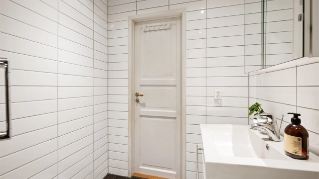 Badet er innredet med vegghengt servantinnredning med ovenpåliggende servant, speilskap med overlys og stikkontakt over servant.