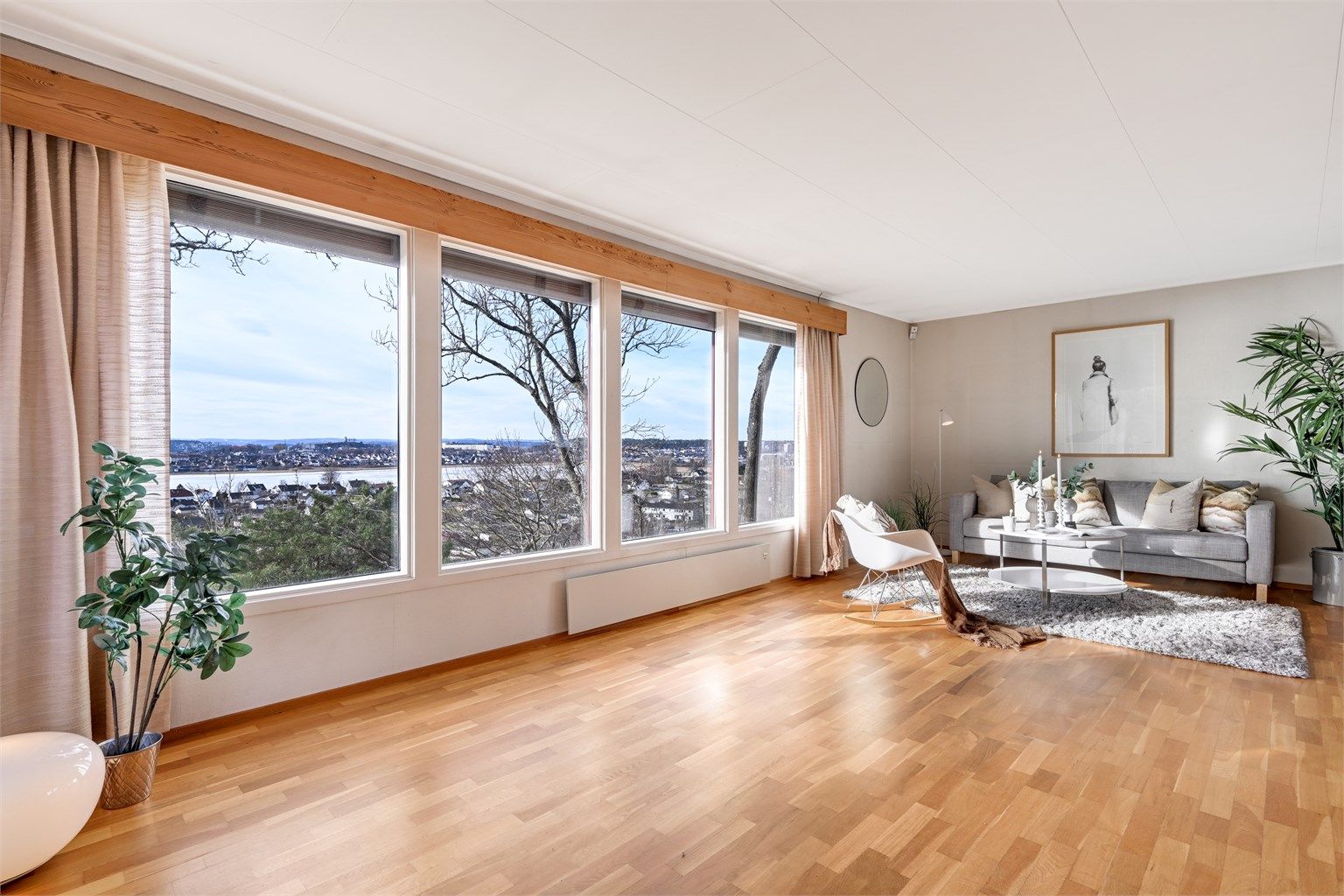 Stuen bader i dagslys fra store vinduer med utsikt du aldri blir lei av.