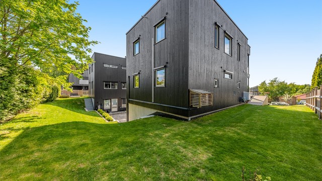 Eiendommen har en pent opparbeidet hage og ligger i et skrånende terreng.