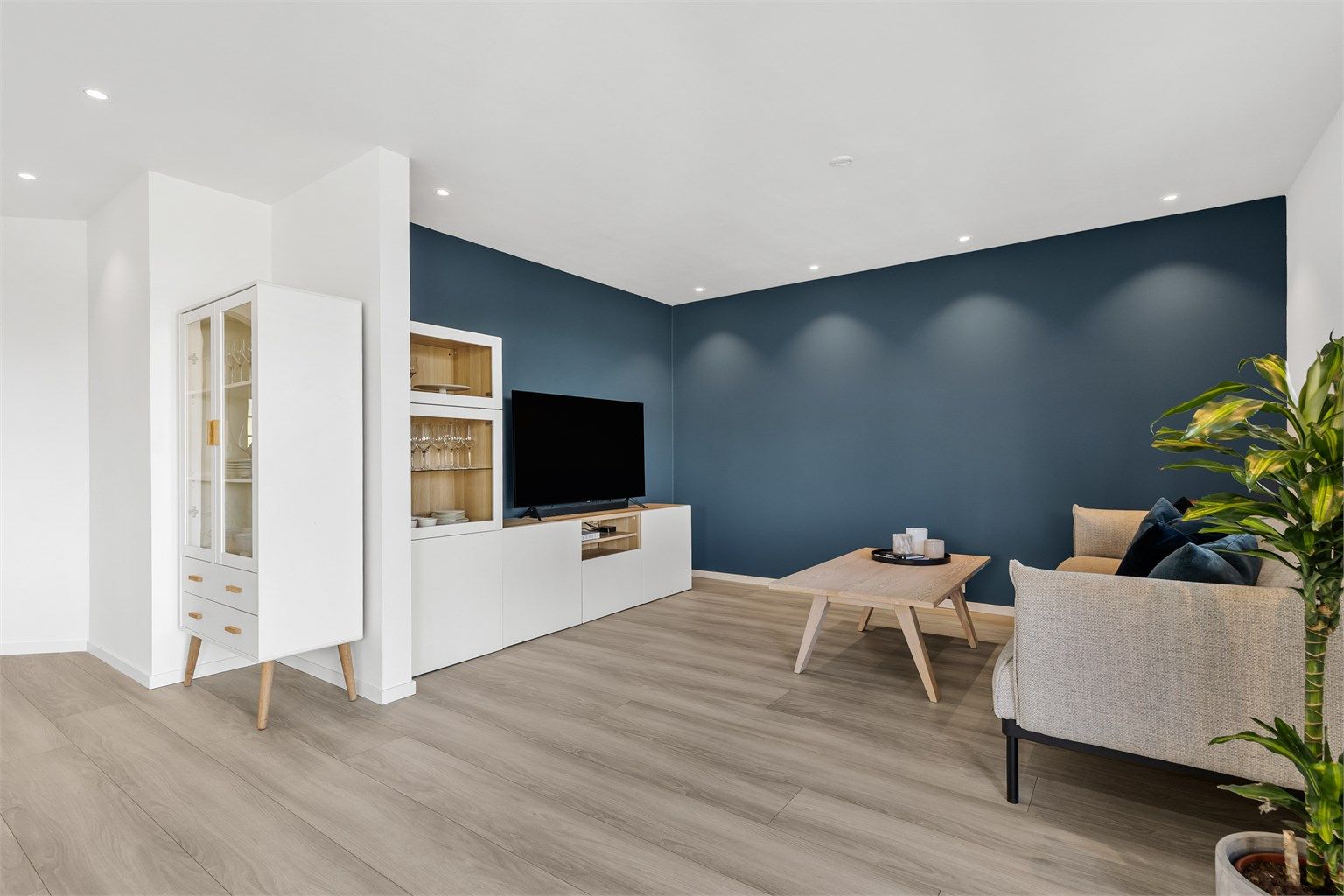 I stuen er det god plass til sofamøblement og TV-møbel, og kontrastveggen skaper en beroligende atmosfære.