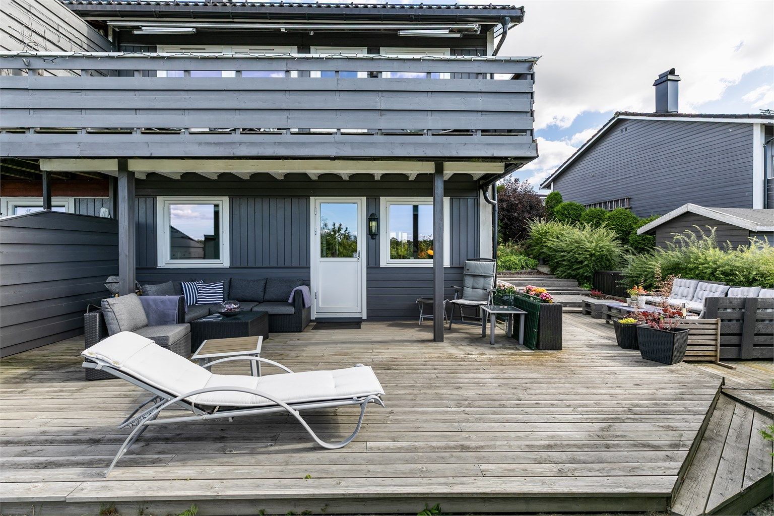 En omfangsrik, sør- og vestvendt terrasse på over 50 kvm. omfavner underetasjen.