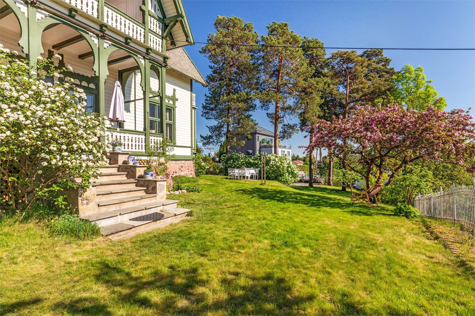 En trapp i naturstein leder fra verandaen og ned til hagen