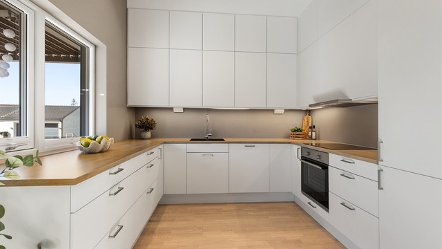 Godt med skap- og benkeplass, samt lys under overskapene, gjør kjøkkenet både praktisk og funksjonelt.