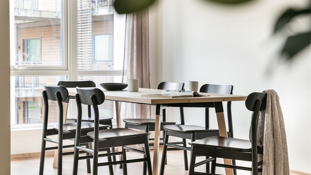 Hjørneform og et romslig areal gjør stuen enkel å møblere med både sofa og spisegruppe.