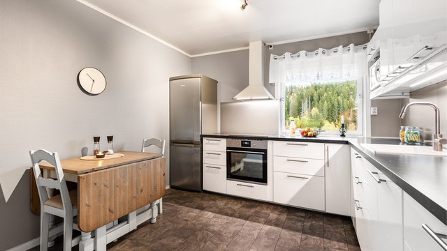 Det er frittstående kjøleskap med fryser og vegghengt ventilator, samt integrert stekeovn, platetopp og oppvaskmaskin. Det er også laminert plate mellom kjøkkenbenk og overskap.