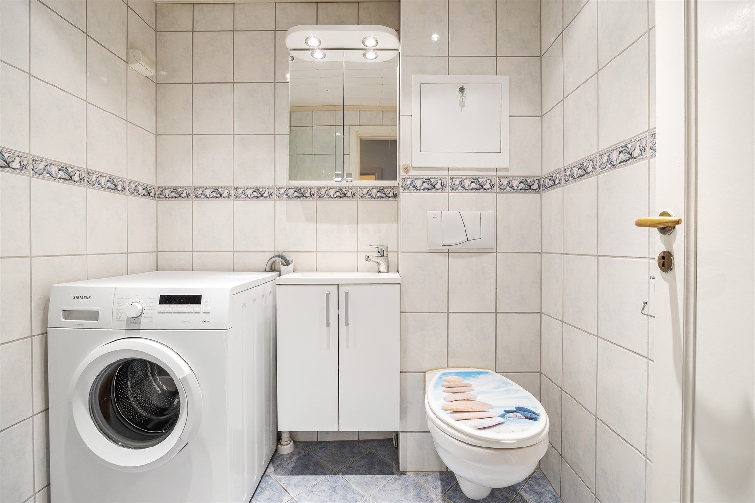 Badet har dusjhjørne, opplegg for vaskemaskin og gulvvarme.
