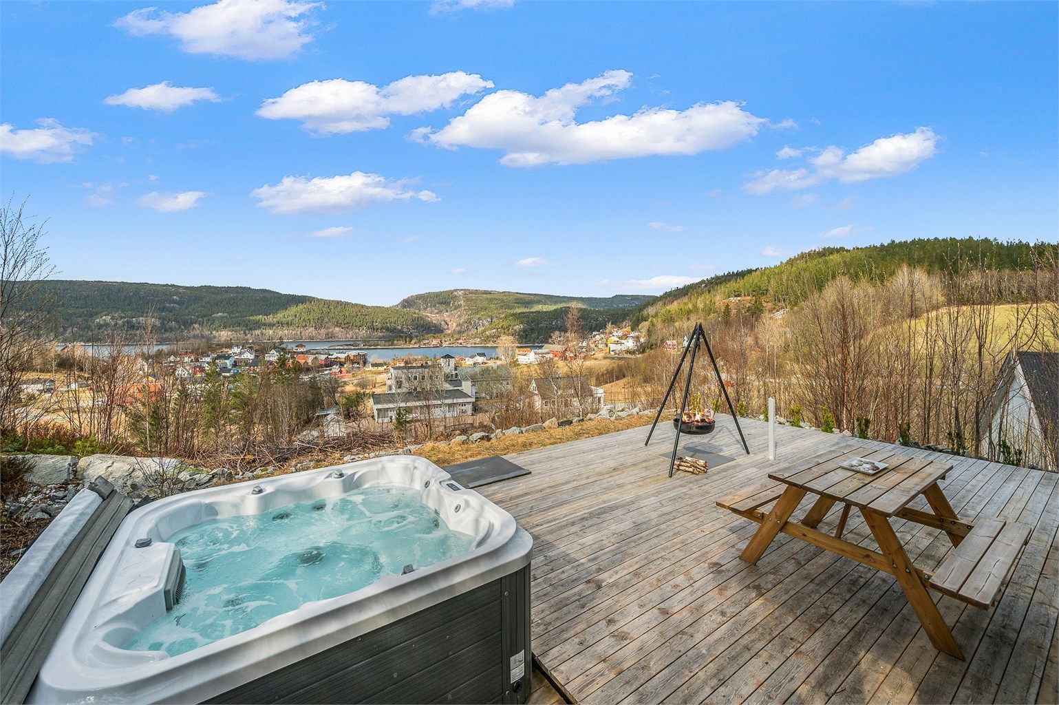 Romslig terrasse med god plass til utemøbler og sosiale sammenkomster, samt bålpanne som skaper en lun og hyggelig stemning.