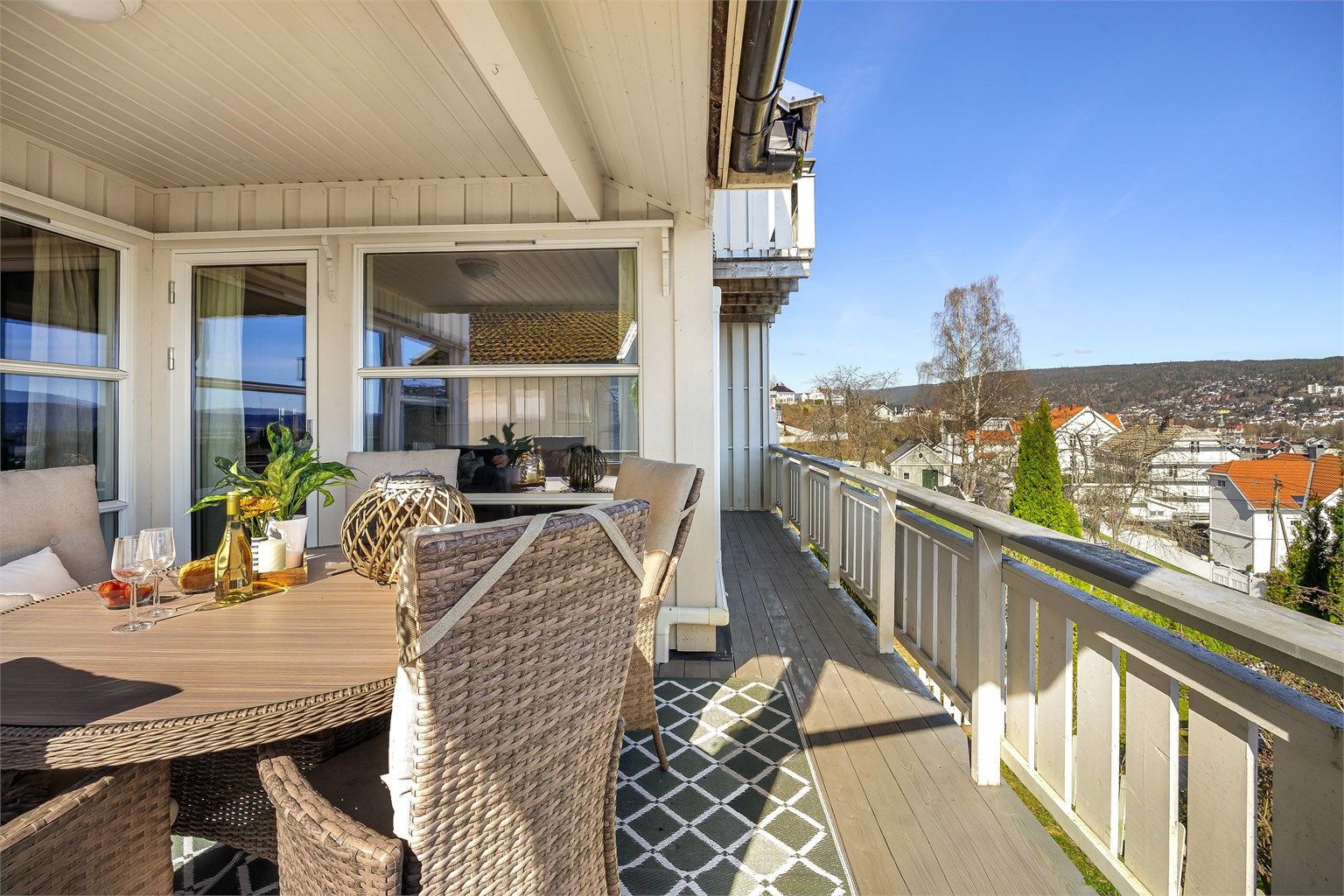 Verandaen strekker seg langs stuen og kjøkkenet, med utgang fra begge rom.