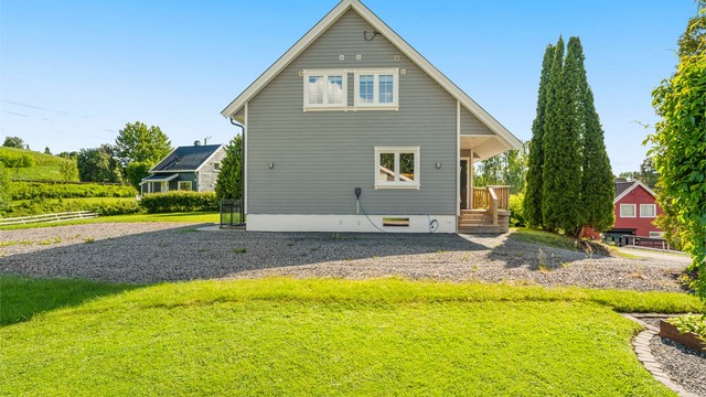 Boligens fasade mot gårdsplassen, med elbillader installert.