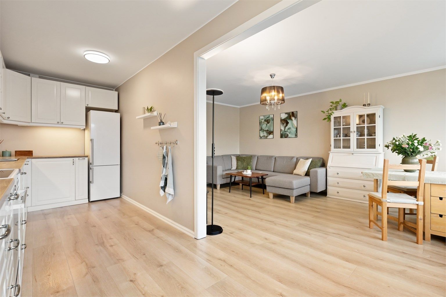 Lys og innbydende stue med delvis åpen løsning til kjøkkenet 