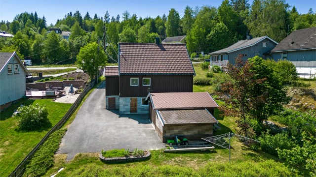 Uteområde - tomt er pent opparbeidet med plen, hekk og diverse prydbusker med skrående og delvis flat tomt