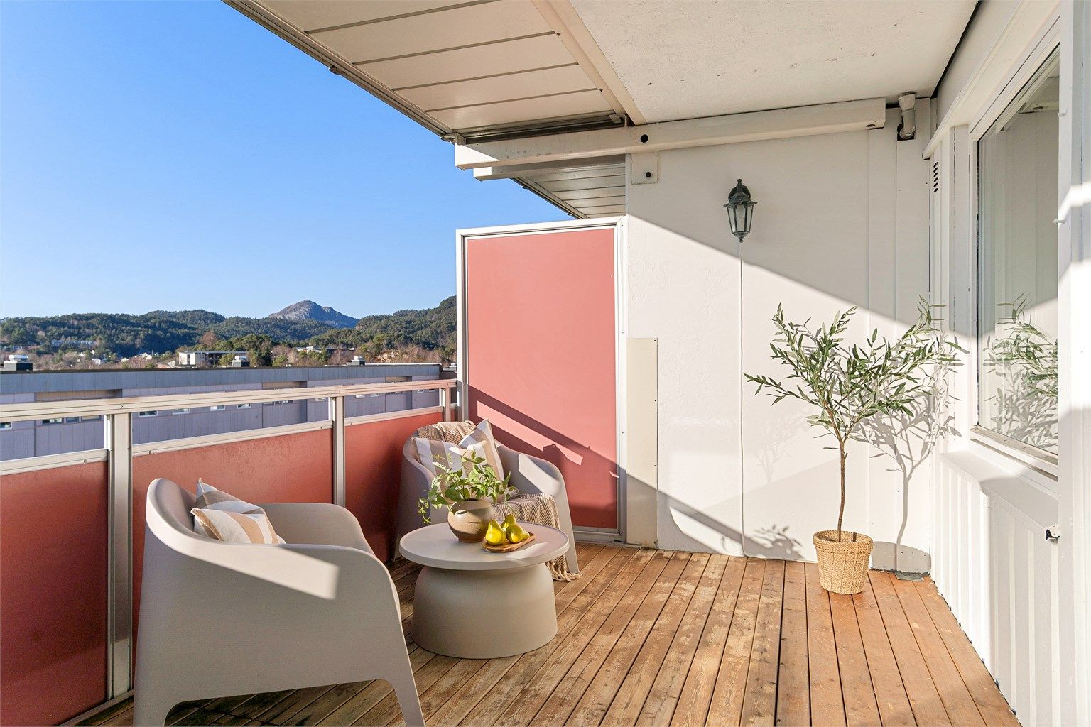 - Utsikt fra balkong. Plasseringen gjør at man kommer høyt nok opp i blokken til å få en langstrakt utsikt over bebyggelse foran og videre mot Lyderhorn -