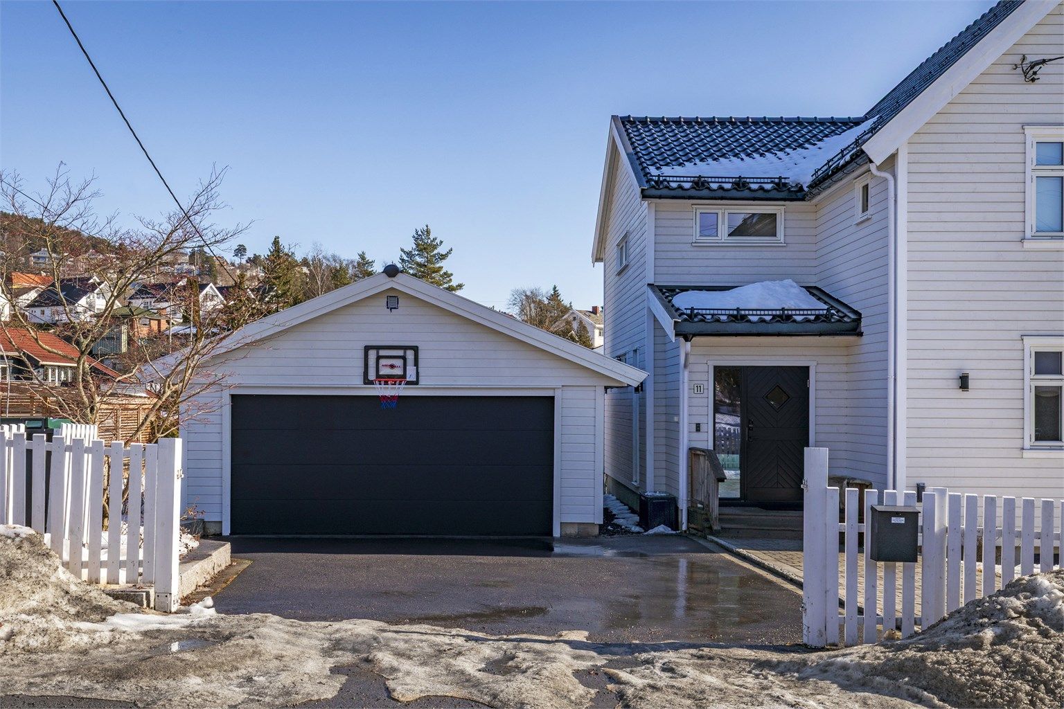 Asfaltert gårdsplass og det er belegningsstein i gangsone inn mot huset