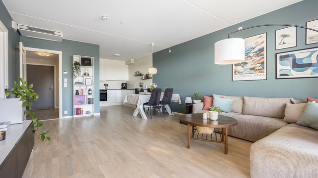 Den åpne løsningen mellom stue og kjøkken skaper en sosial og luftig sone med en takhøyde på 2,57 meter.