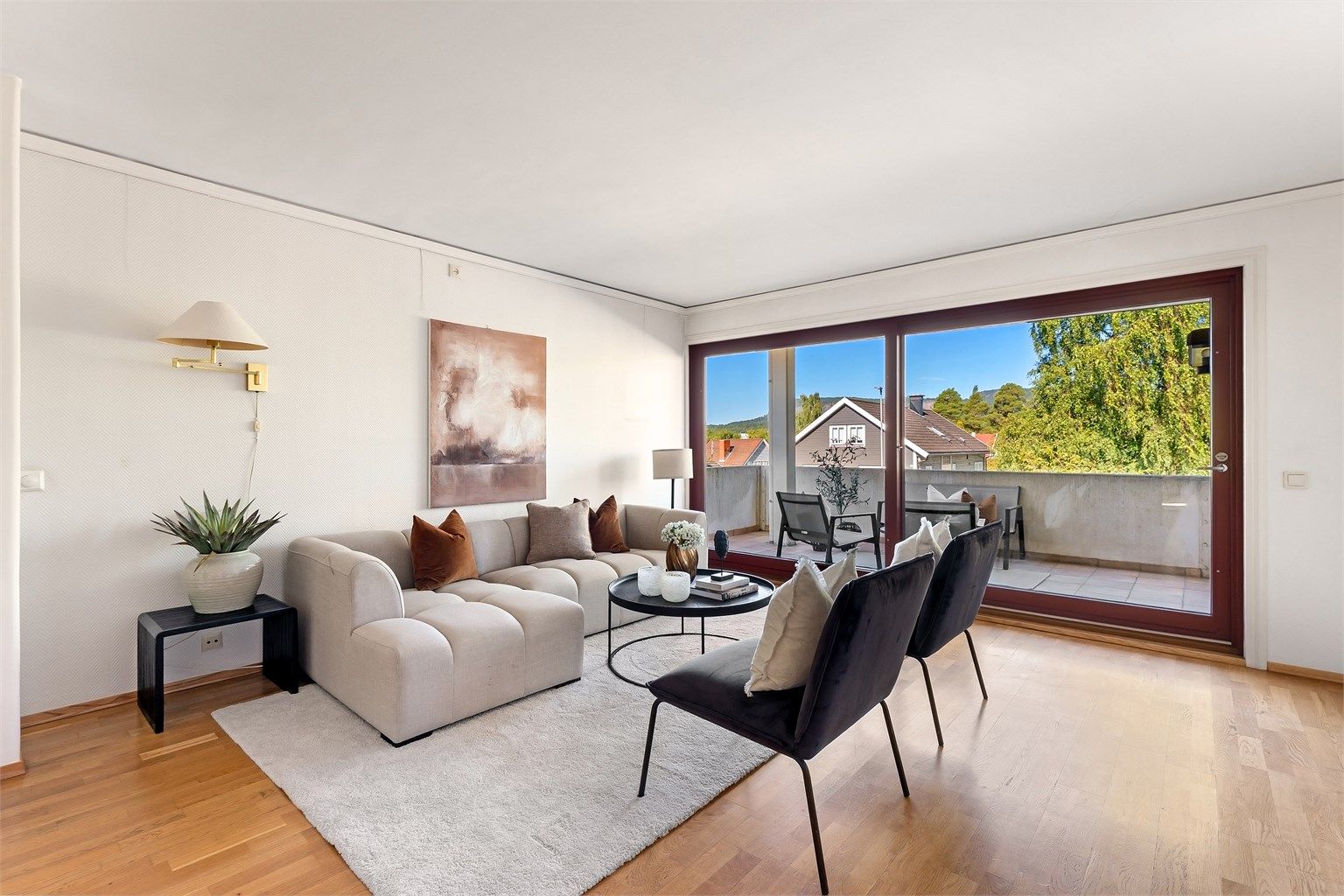 Stuen har god plass til sofagruppe og utgang til en romslig balkong på 12 m².