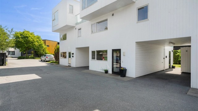 Romslig carport med el-billader. Praktisk biinngang fra carport.