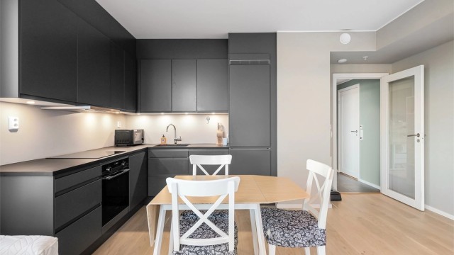 Stilrent kjøkken fra Sigdal med slette fronter og laminatbenkeplate med underlimt oppvaskkum.