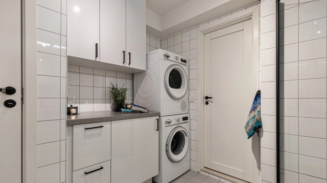 Det er en praktisk nisje med opplegg for vaskemaskin og god oppbevaring.