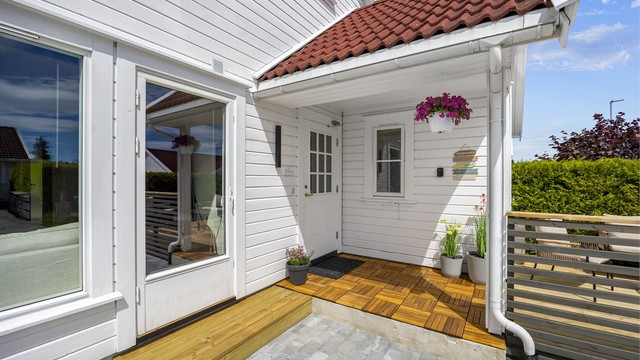 Overbygget inngangsparti med ny platting i behandlet tre.