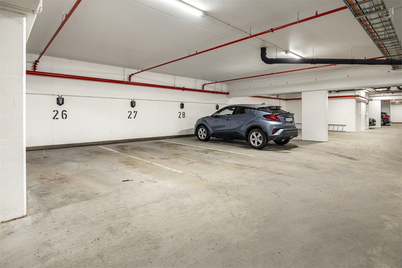 Medfølgende disponibel parkeringsplass (nr. 27 iflg. selger) med el-billader i felles garasjeanlegg. 