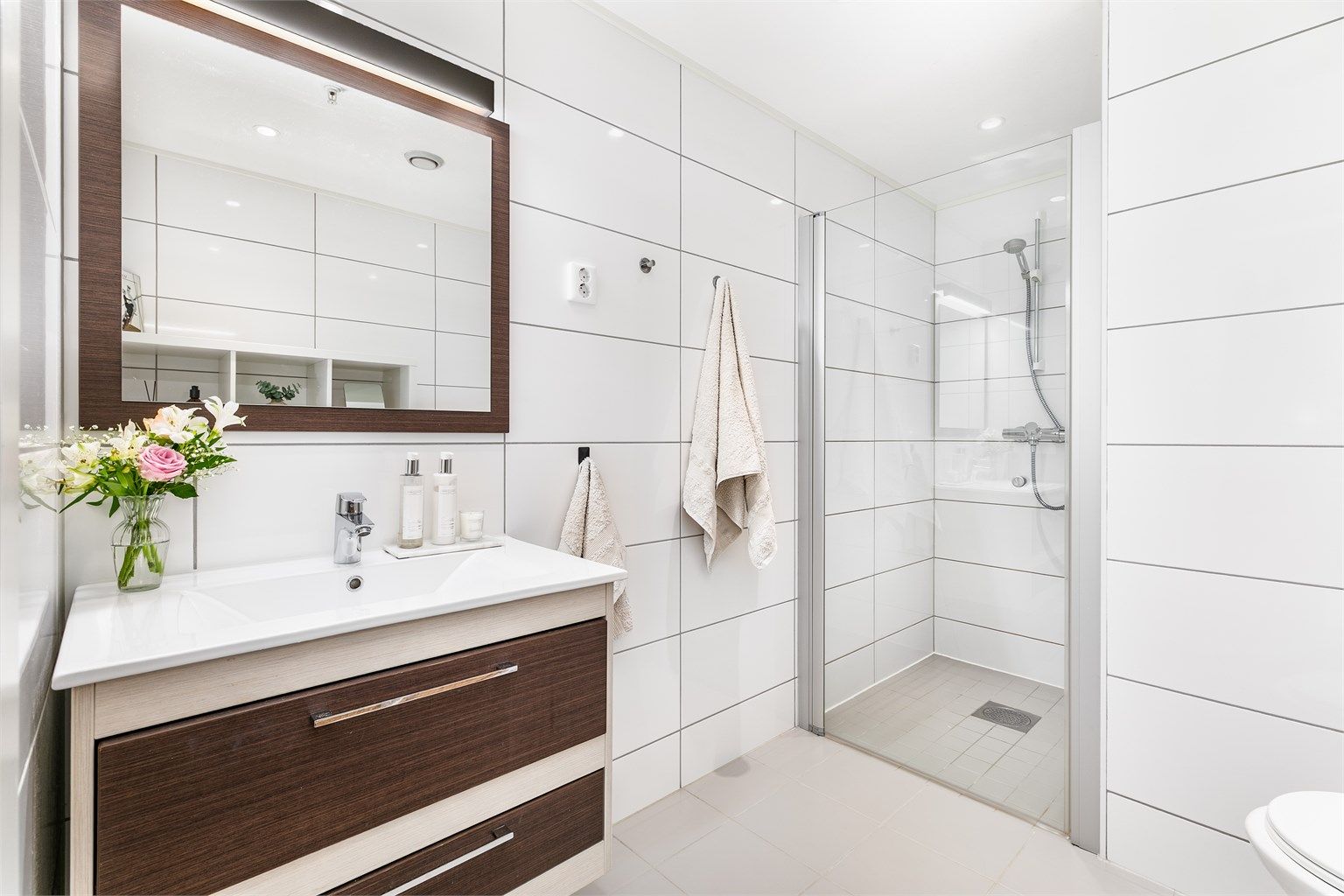 Badets gulv og vegger er flislagt. Spotter er innfelt i himlingen og kan dimmes til ønsket styrke.