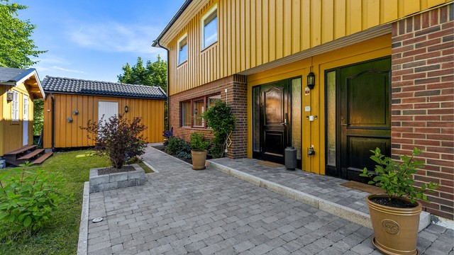 Inngangsparti med dør til hoveddelen på venstre side og utleiedelen på høyre side