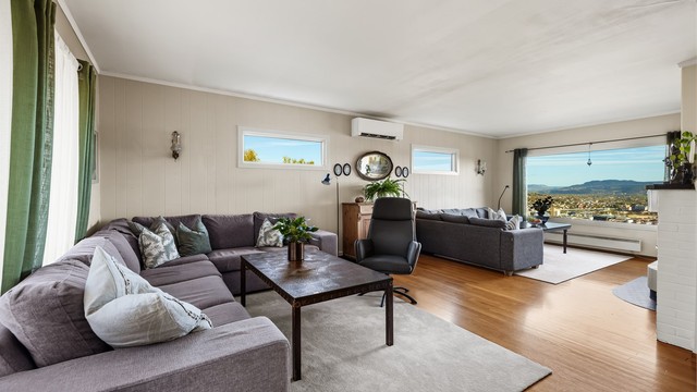Romslig vinkelstue med to sofaområder og sittegruppe.