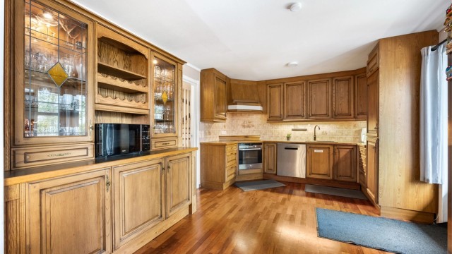 Kjøkkeninnredning med profilerte fronter fra ukjent årstall, benkeplate med laminert flate og nedfelt oppvaskkum i kompositt med ett-greps armatur.