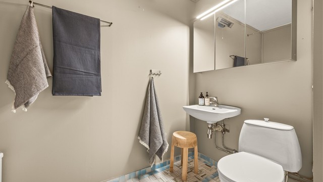 Det ene av leilighetens to bad. Badet er fra byggeår, og modernisering må påregnes.