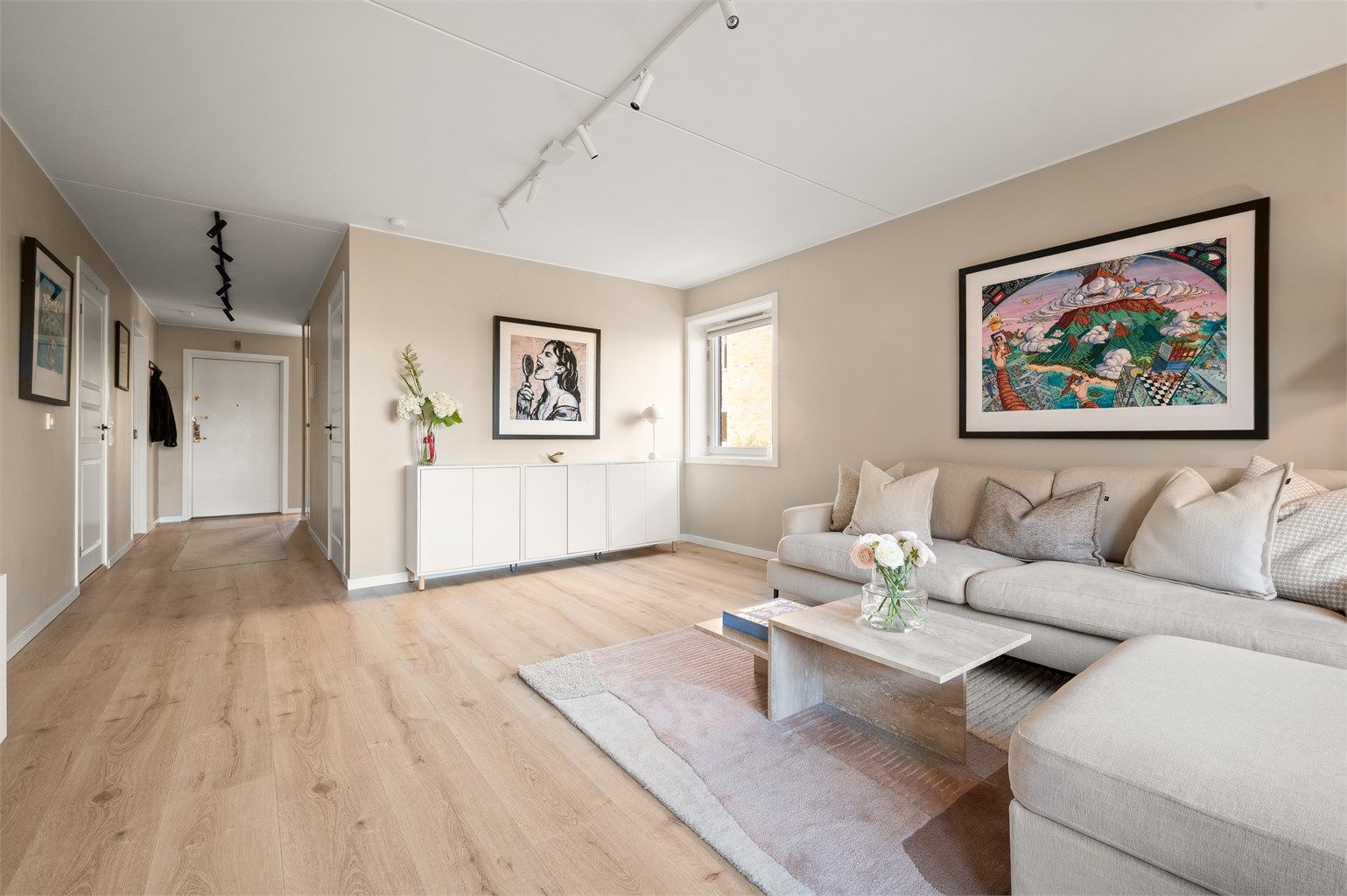 Den romslige stuen har en åpen og luftig følelse, med god forbindelse til resten av leiligheten.