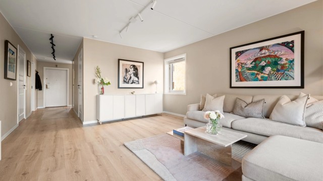 Den romslige stuen har en åpen og luftig følelse, med god forbindelse til resten av leiligheten.