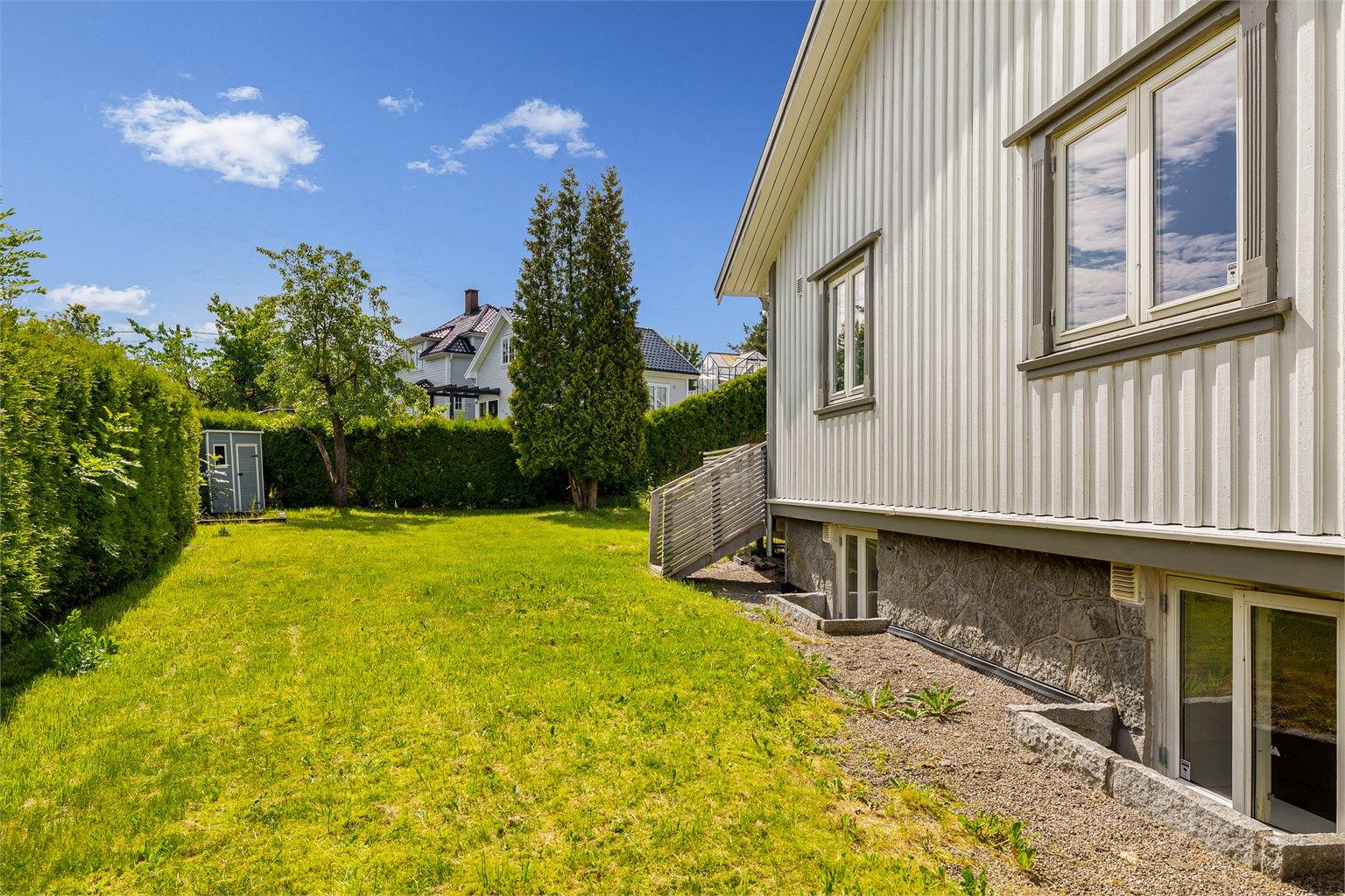 Stor hage som strekker seg rundt boligen.