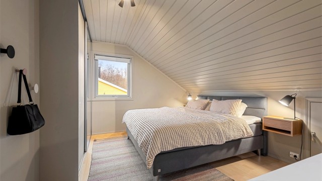 Hovedsoverommet i loftsetasjen har en romslig skyvedørsgarderobe.