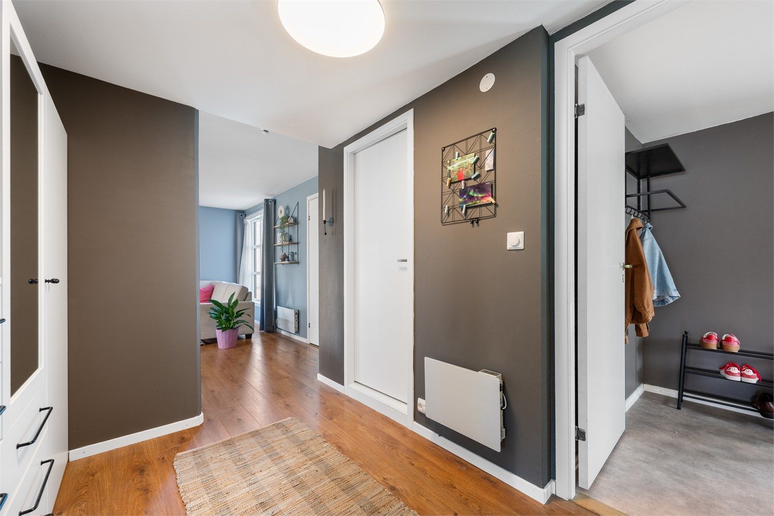 Videre fra entré kommer man inn til gang, hvor man også kan ha garderobeskap eller eventuelt en skrivepult og et hjemmekontor. Det er parkett på gulv og malte vegger