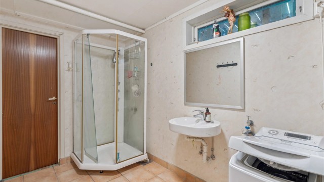 Badet er utstyrt med dusjkabinett og opplegg for vaskemaskin.